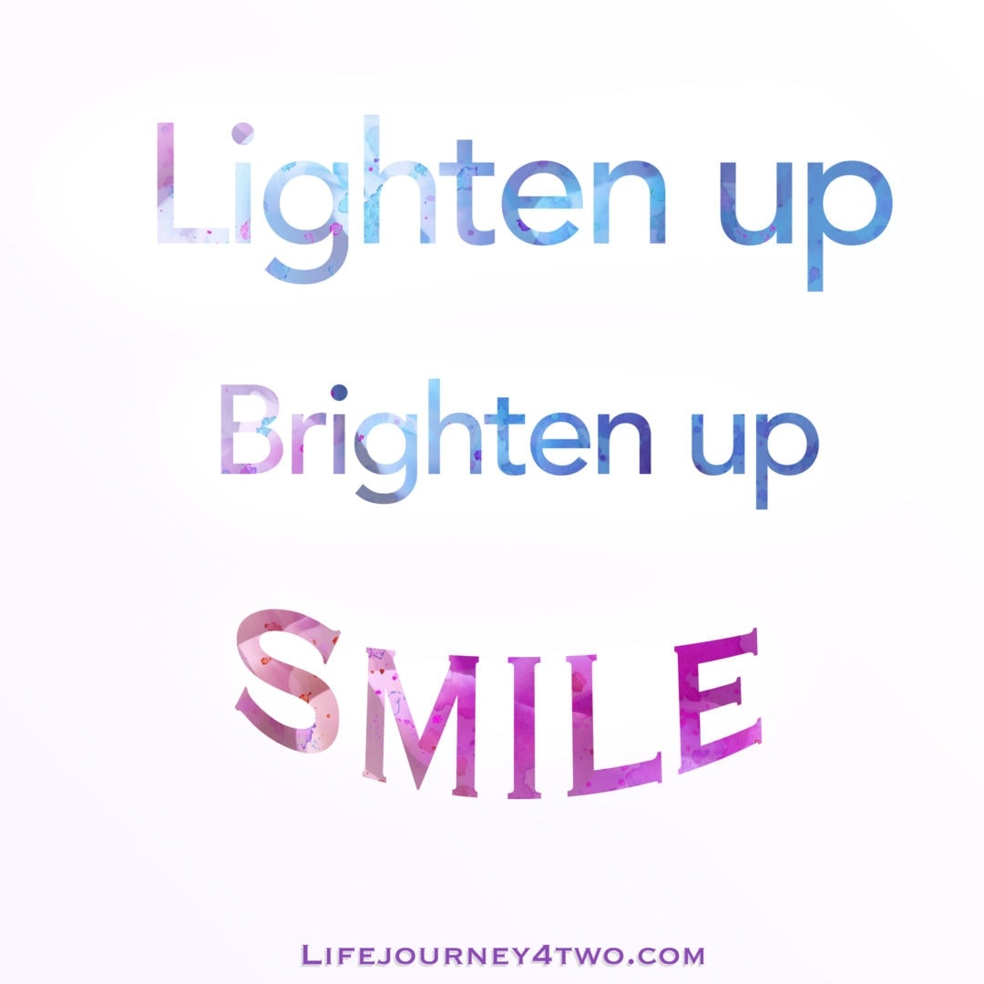 lighten up, brighten up smile caption in blue and pink