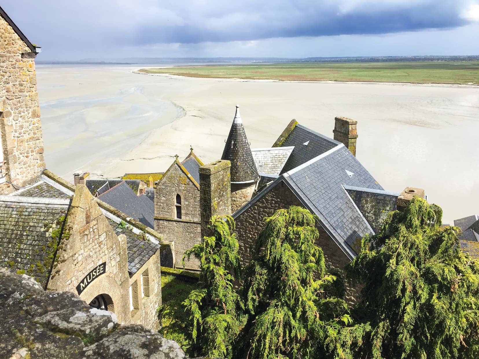 Views from high castle walls over tidal mud flats