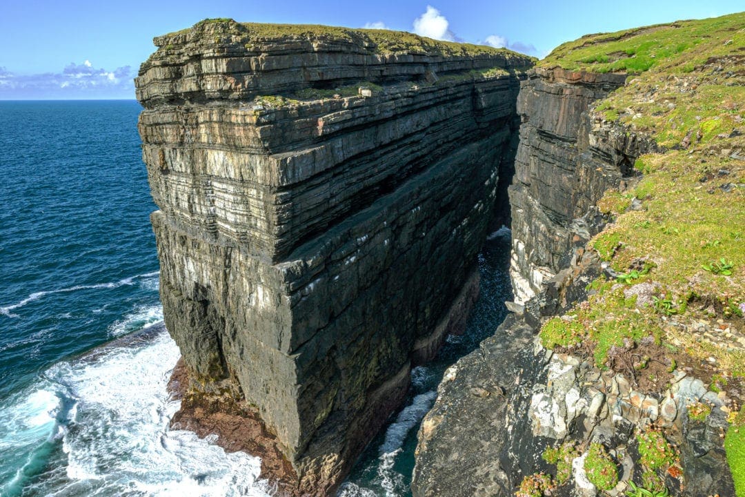 Ireland Landscape Photography: tall slab of rectangular rock rising up from the sea