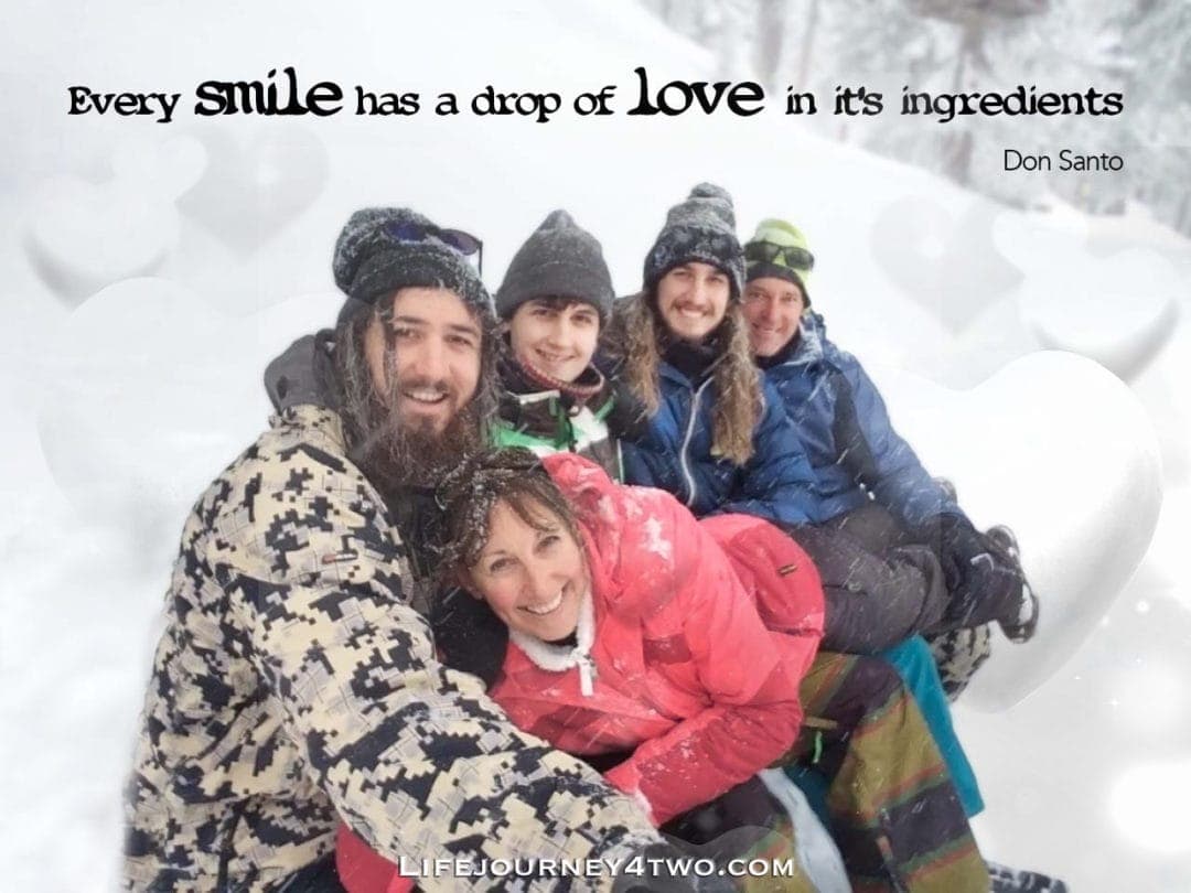 family smiling with smiling caption - every smile has a drop of love  in its ingredients
