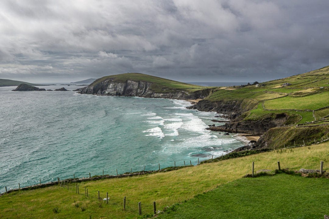 Ireland Landscape Photography: Views to a rocky promontory over green fenced fields