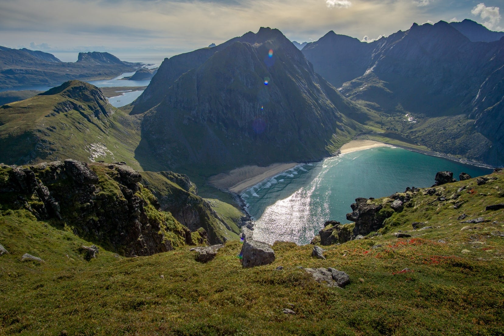 Views-over-a-white-sandy-beach-with-a-mountain-overshadowing-it