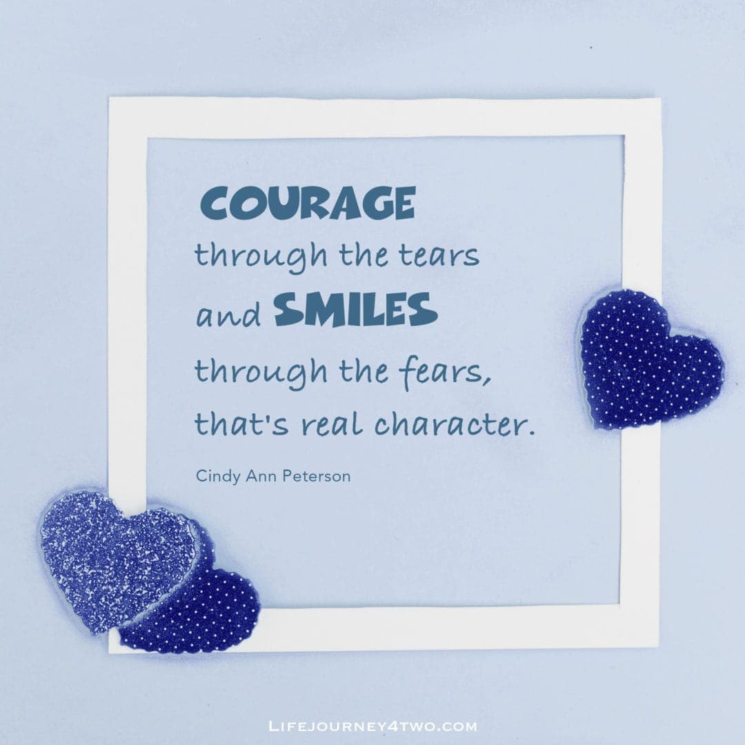 courage and smile caption on blue heart background