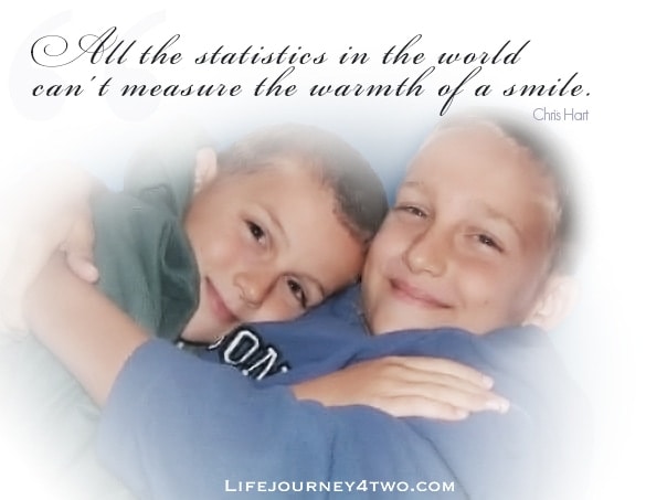 two boys smiling with caption all the statistics in the world can't measure the warmth of a smile