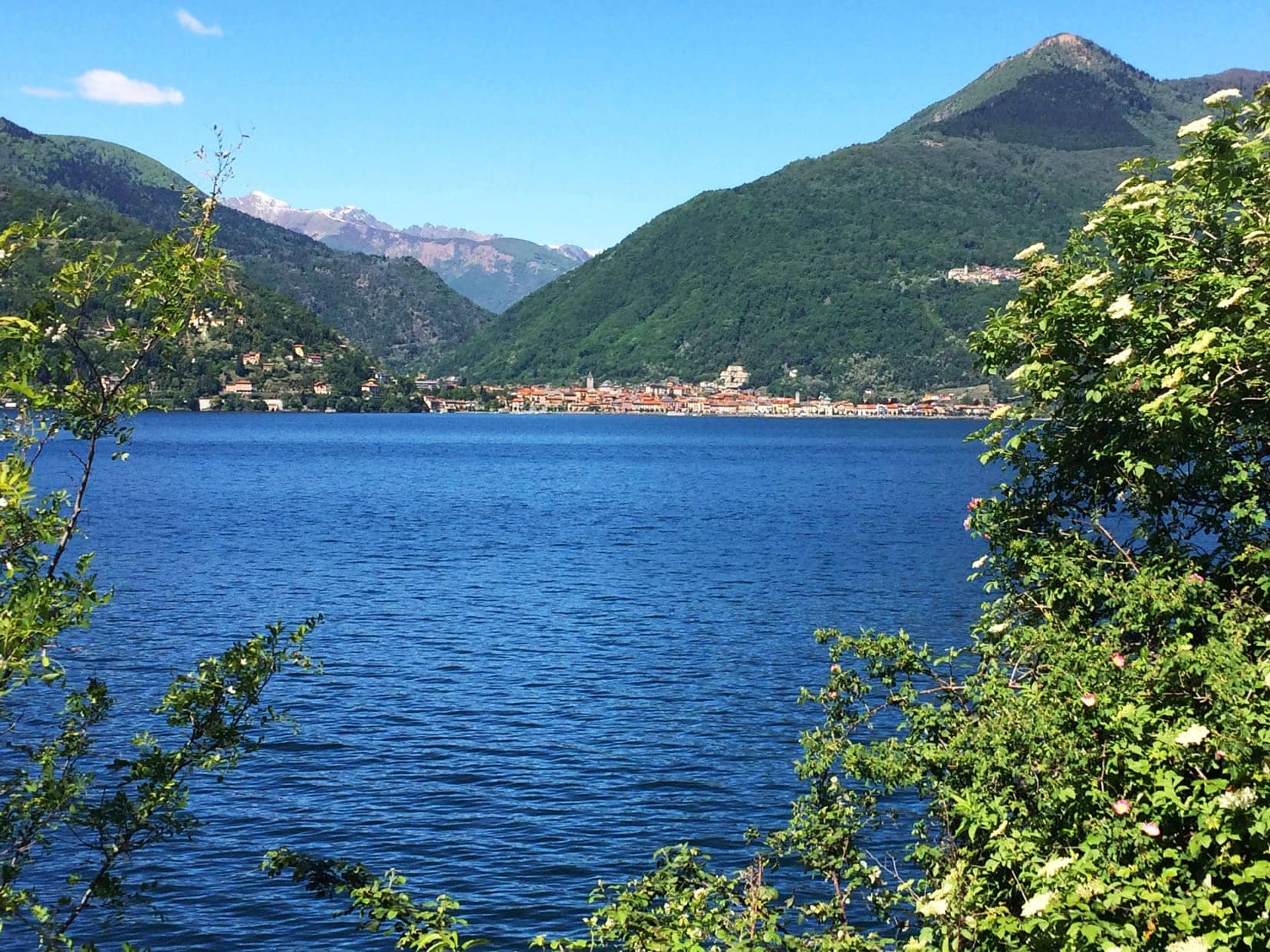 blue lake Maggiore with green mountains in the background on our italy by campervan trip