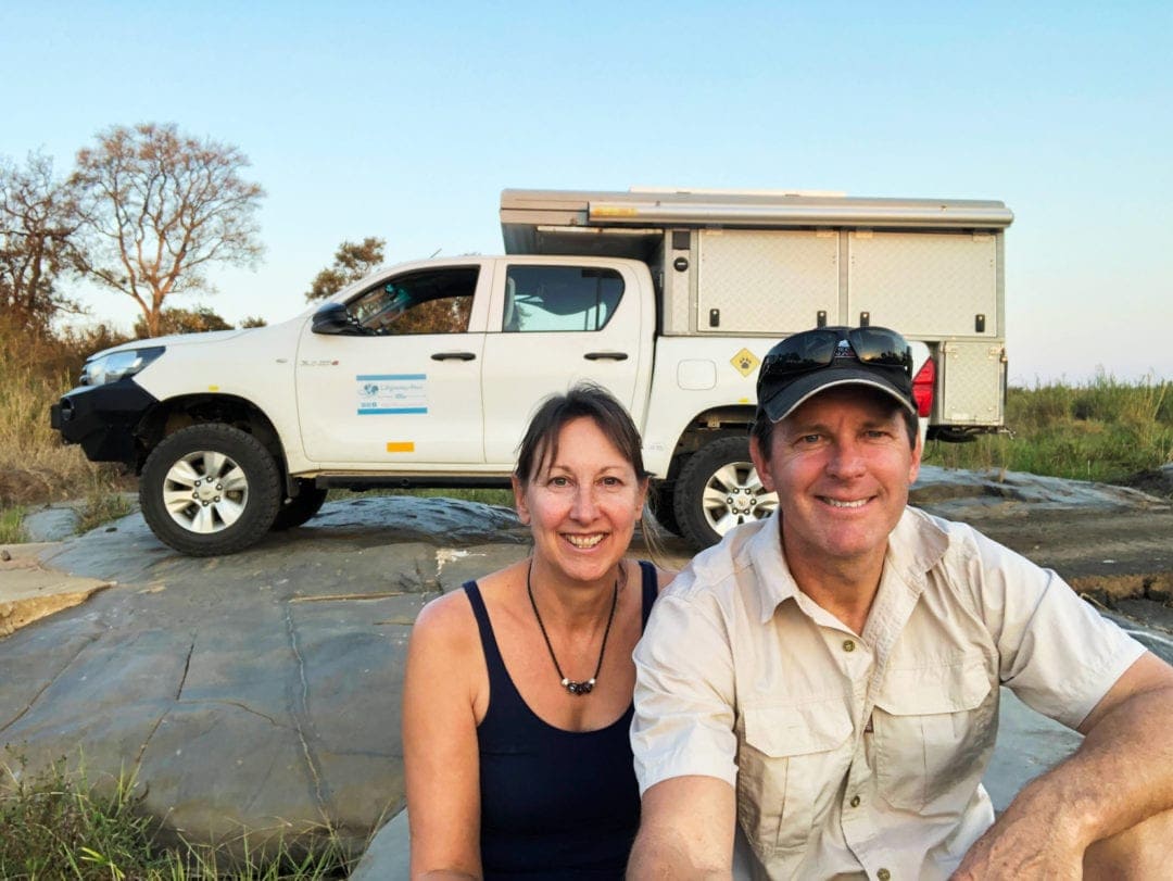 Lars and Shelley  sat in front of bush camper in South Africa