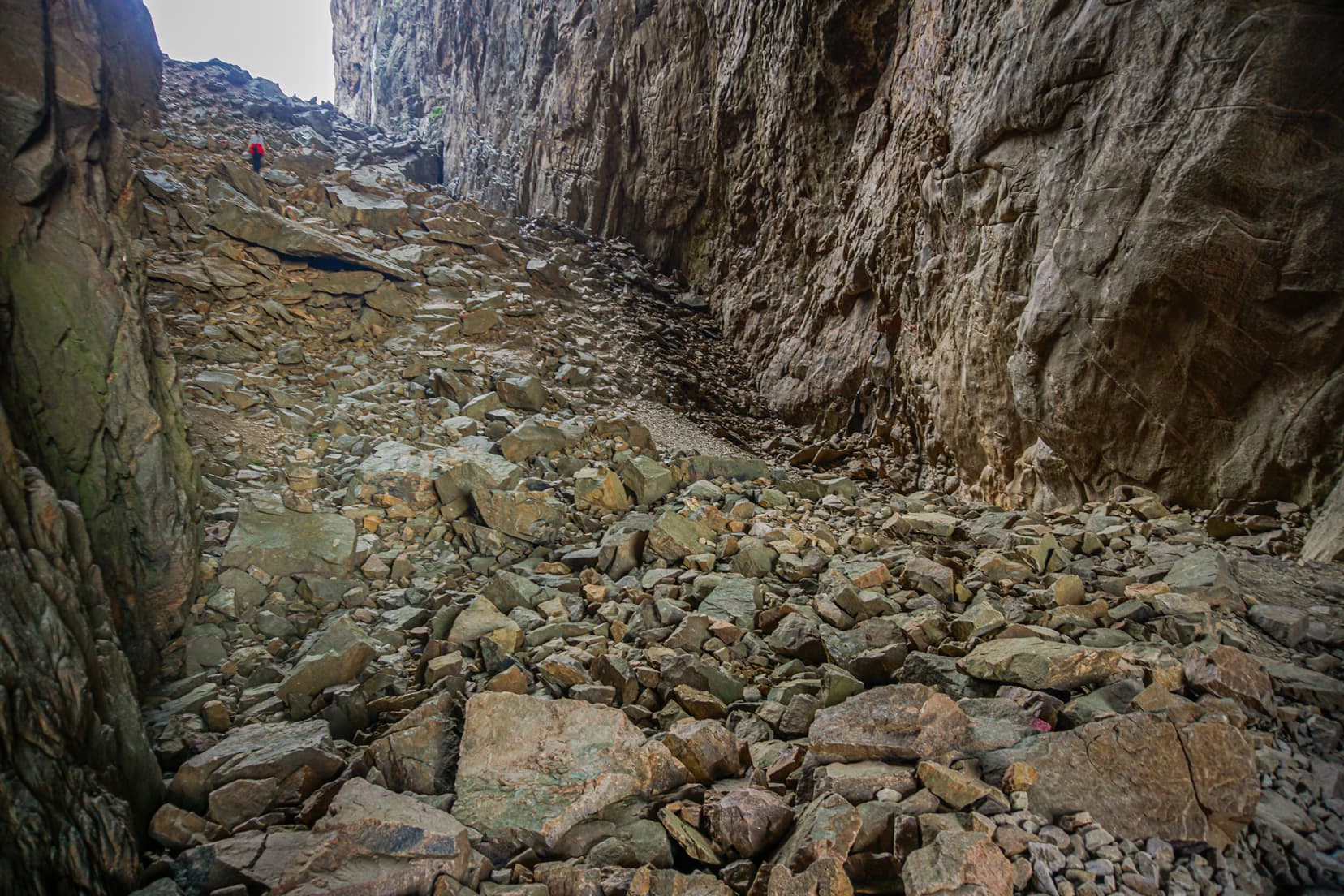 Rocky-cavern-floor-with-a-lady-looking-at-the-opening