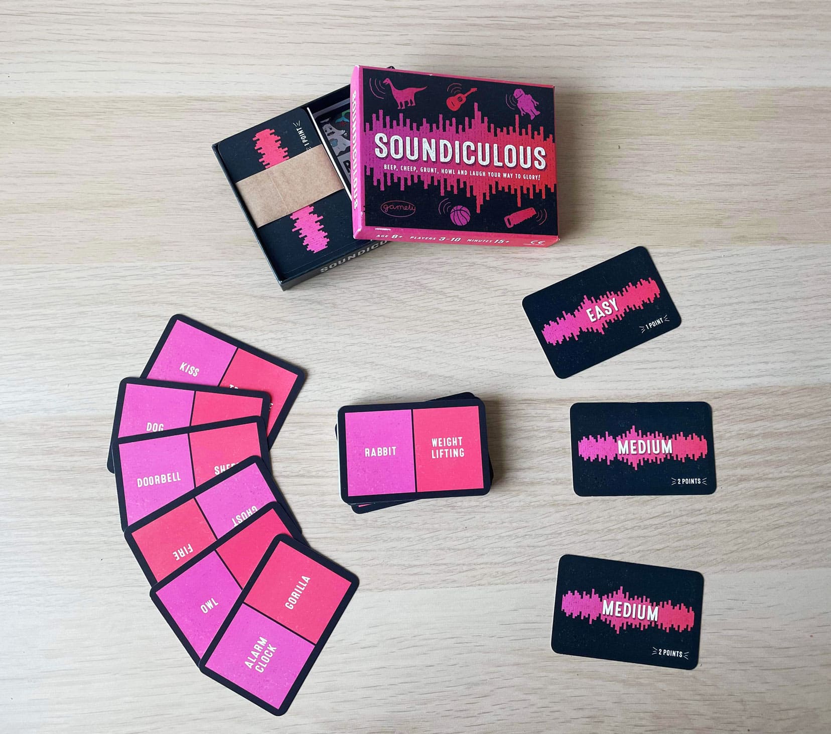 Pink and black cards with various words on as part of the Soundiculous travel game