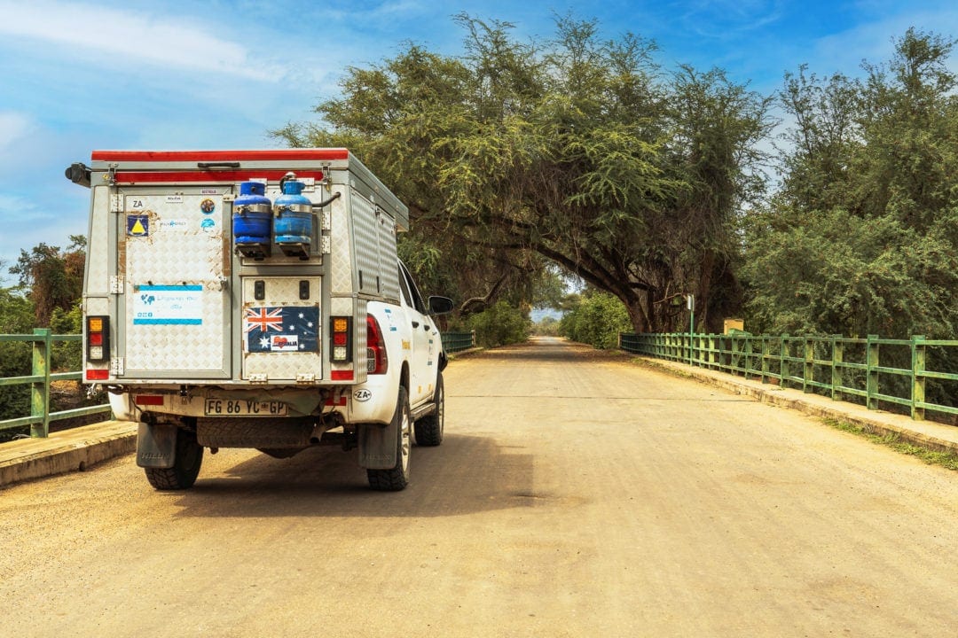 bush camper on sandy coloured road