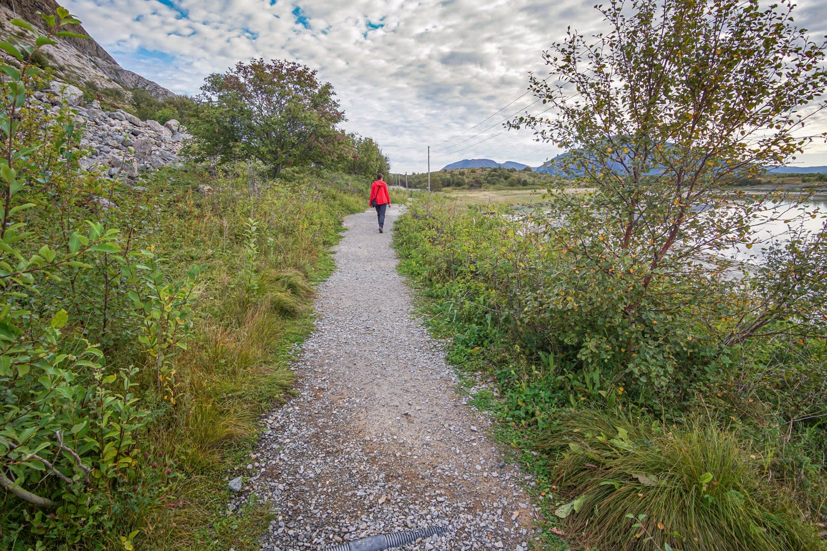 lady-walking-along-a-concrete-path-near-the-sea