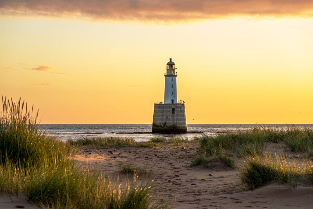 Rattray head lighthouse seen through the sand dunes