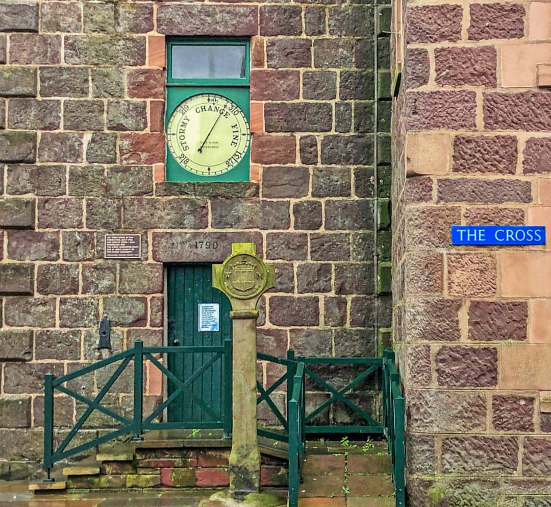 clock tower barometer and green entrance door