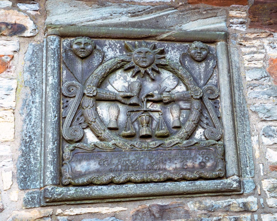Plaque on a wall in Dean Village with symbols of bread making