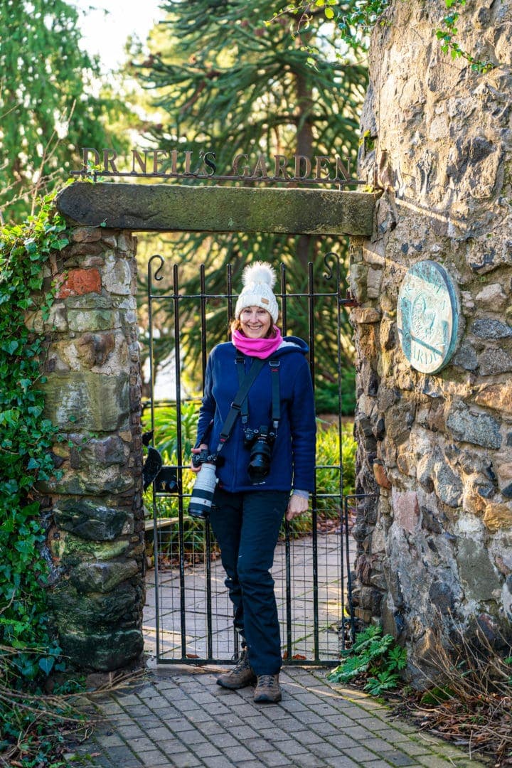 Entrance to Dr Neils Garden with shelley stood in front of the iron bar gate 