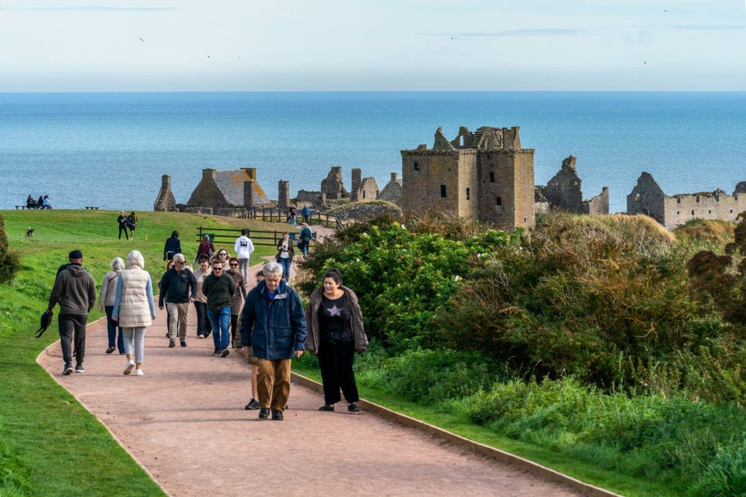 Tourists walking on the  Dunnottar Castle path