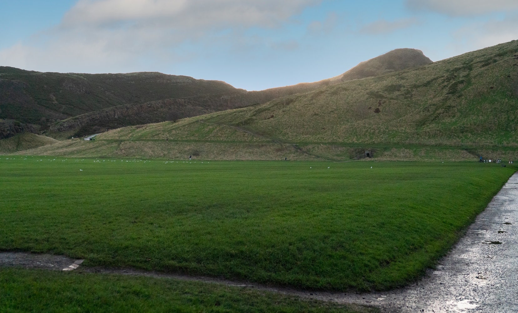 open grassland of Holyrood park with Arthurs seat in background