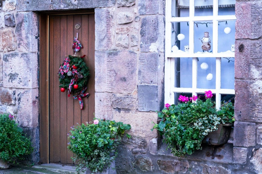 house-in-dean-village with flower boxes in the window and christmas wreath on the door