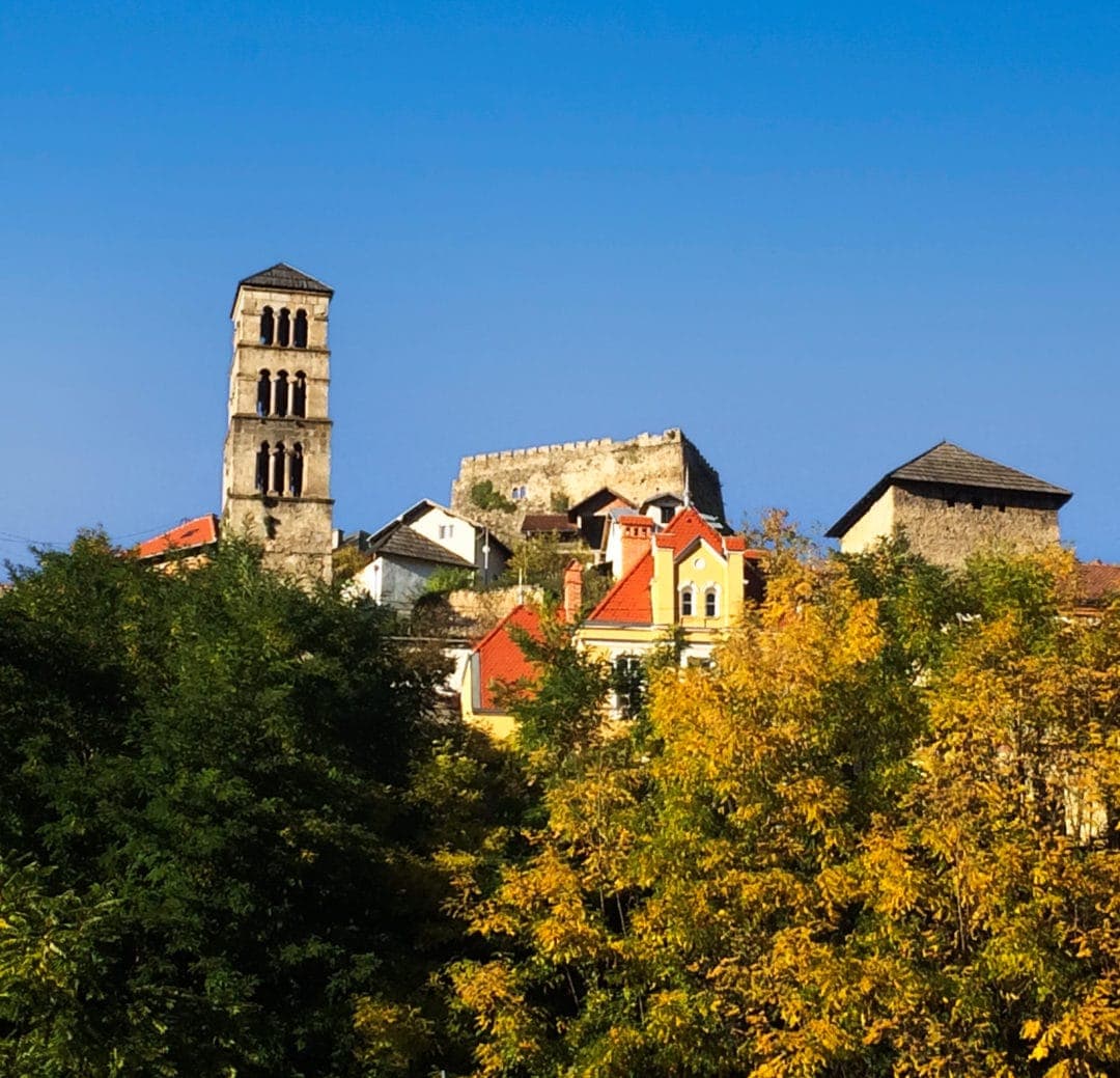 The clock tower at Jajce on the top of a wooded hill