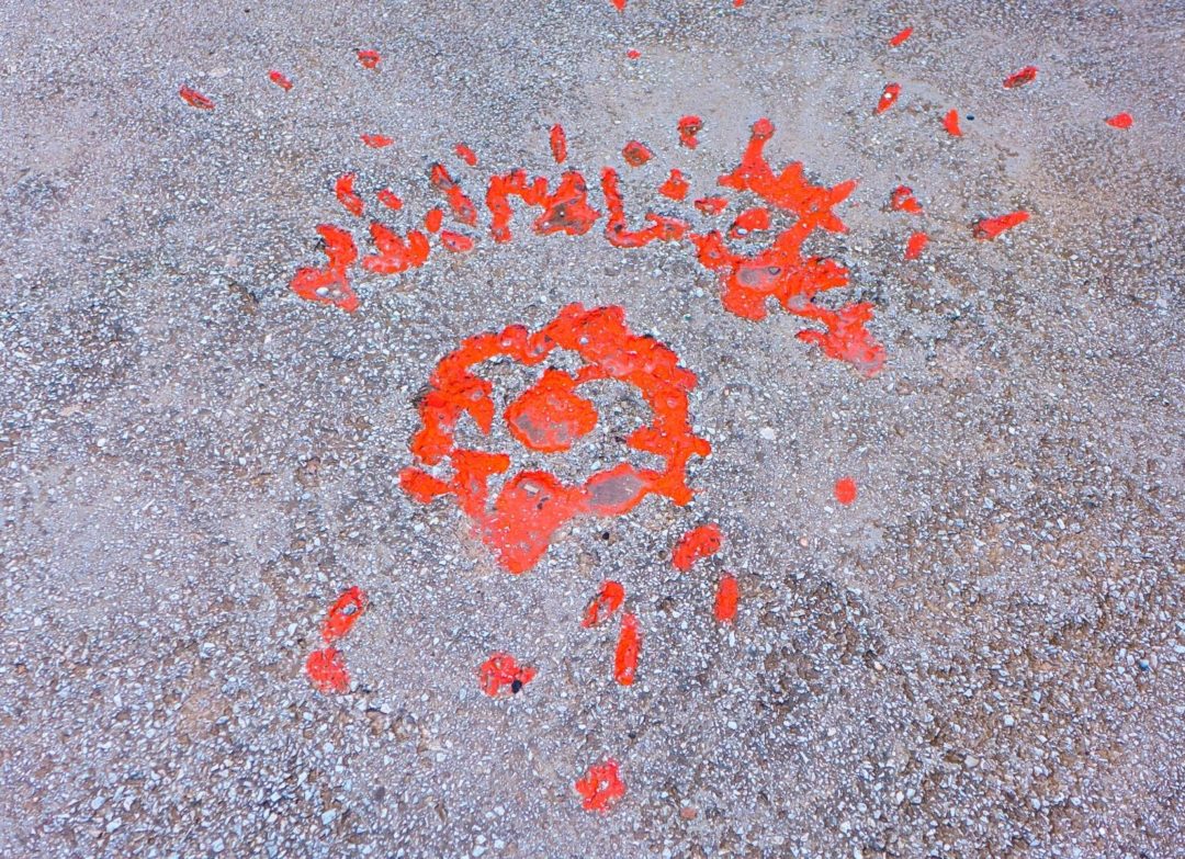 Red resin paint painted on the mortar shell explosion scars on the concrete in Sarajevo