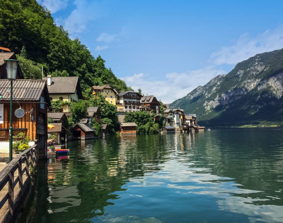 Halstatt houses on the edge of the green blue lake surrounded by mountains