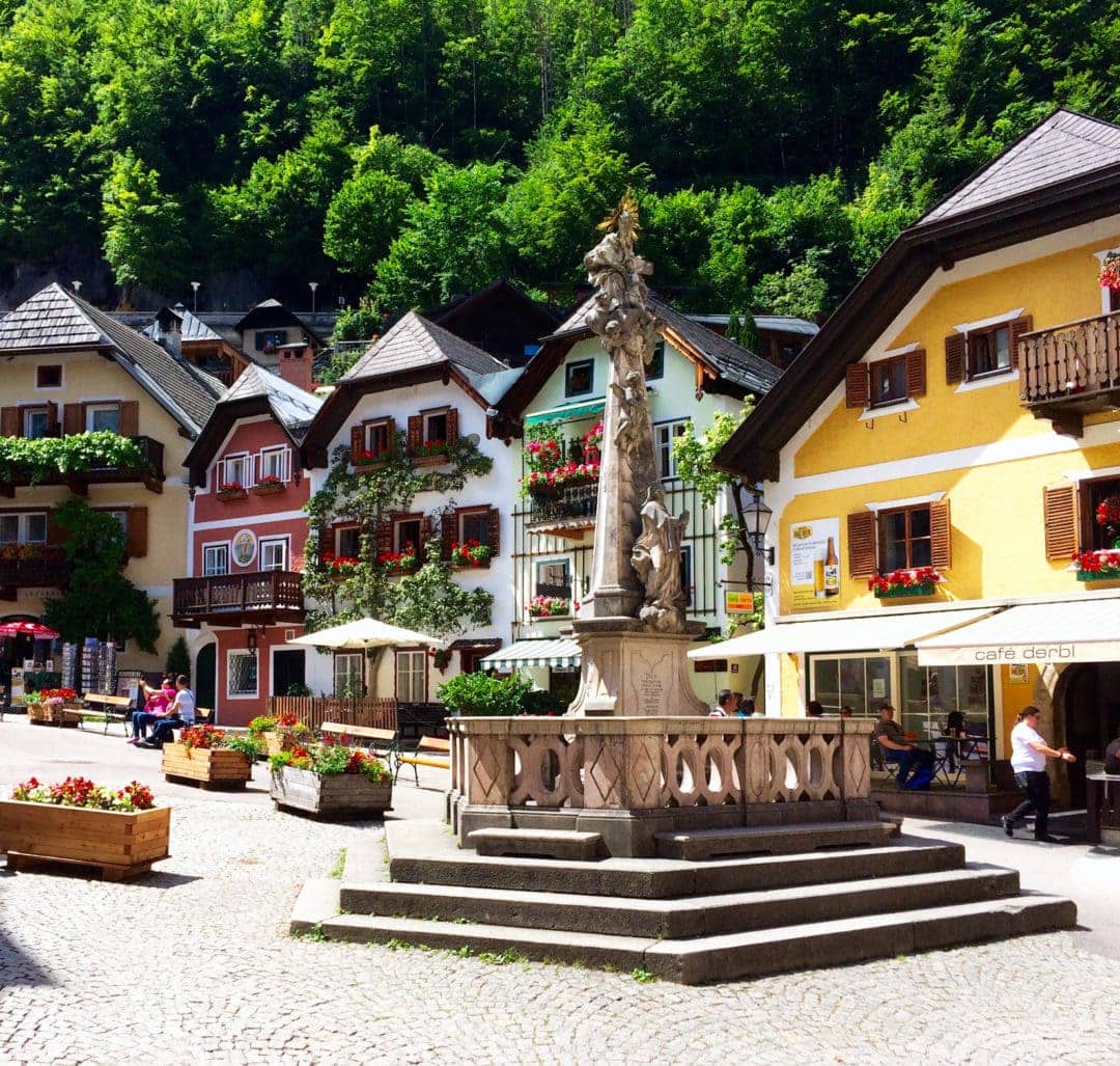 Halstatt-centre withalpine style buidings with window boxes full of flowers and colourful facades