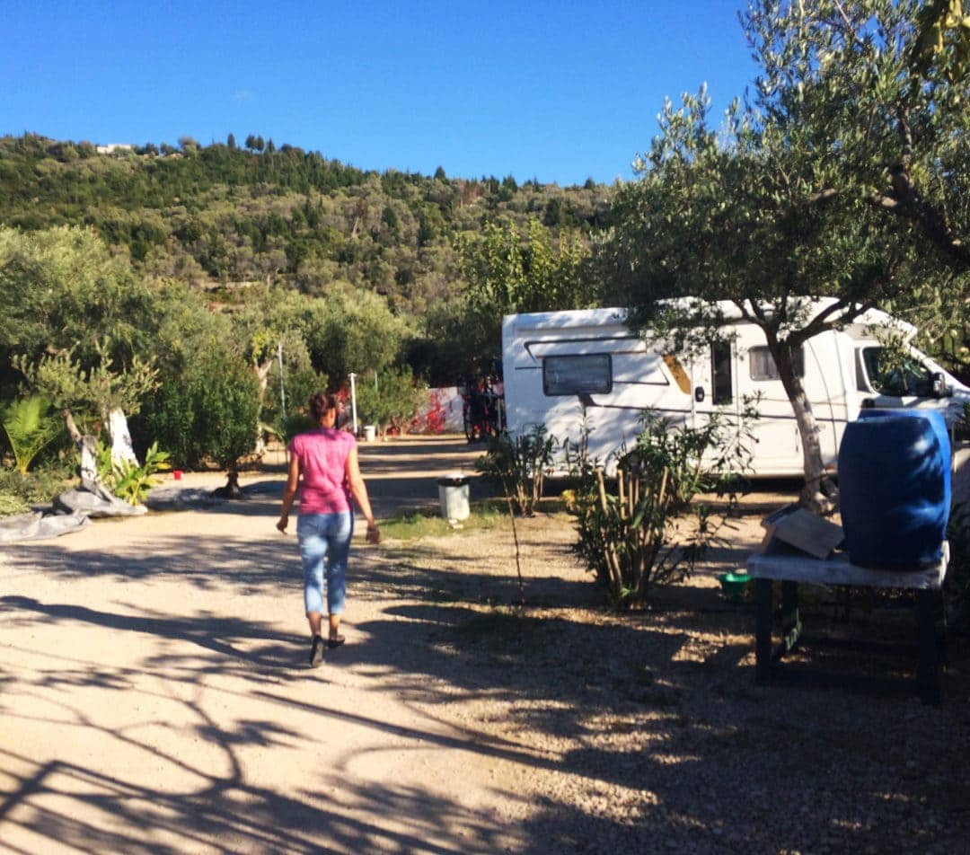 Himare-Campervan-stop-Albania photo of shelley walking towards the motorhome with olive trees all around