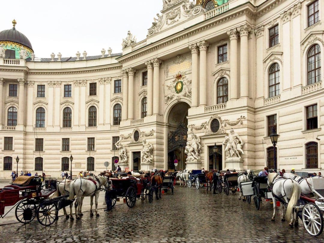 Hofburg-Complex-Vienna with horse and carriages lined up 