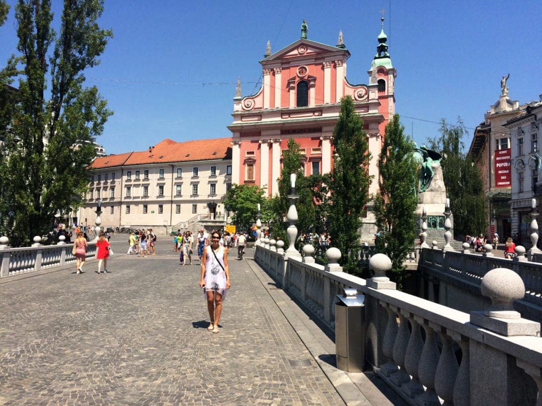 Lady walking across a wide bridge