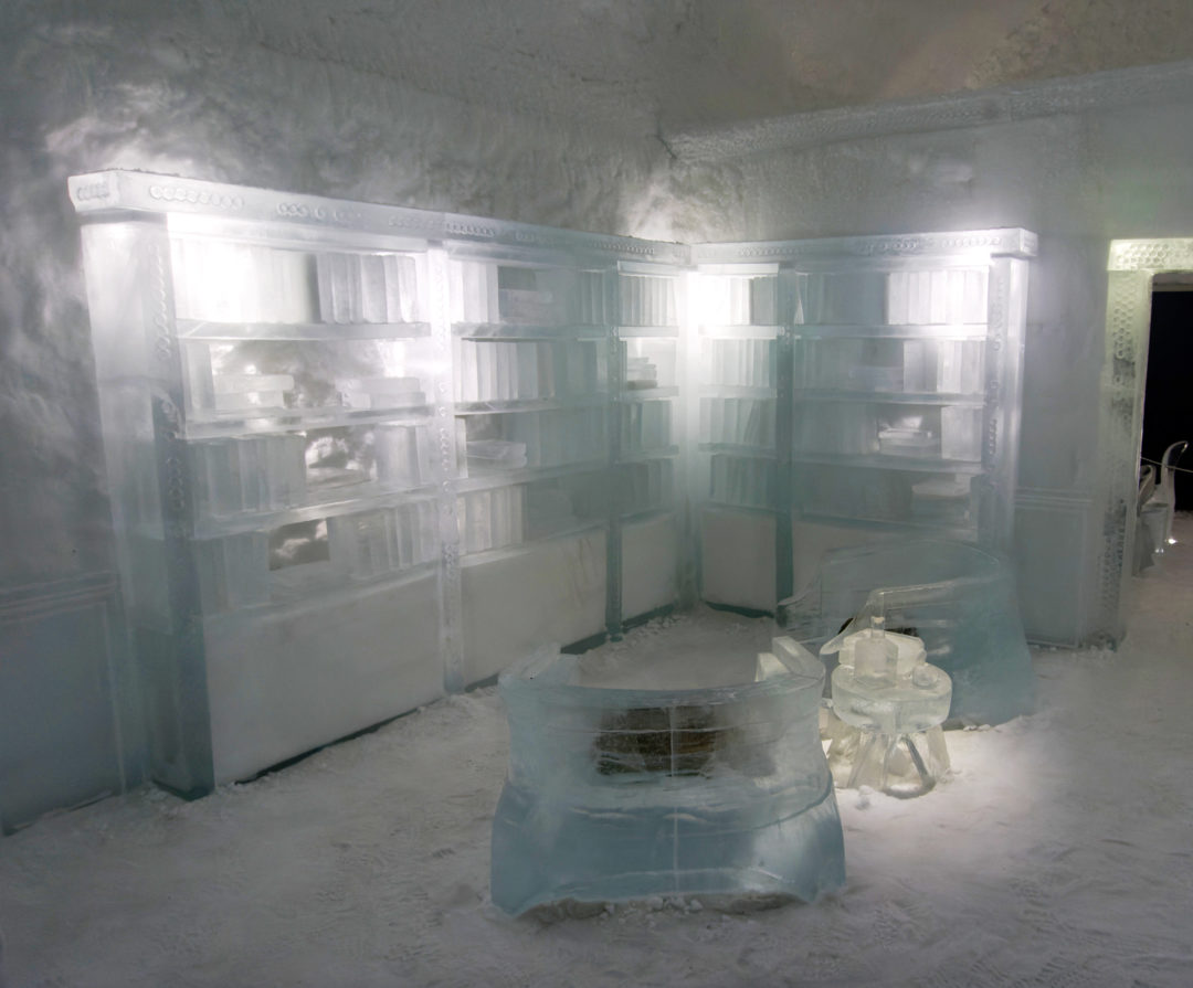 Bookcases-made-of-ice in one of the deluxe bedrooms of the ice hotel