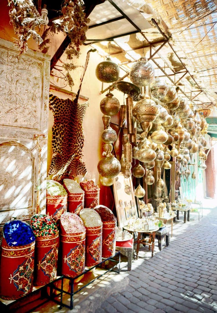 Market stall in Marrakech with spices and hanging lanterns