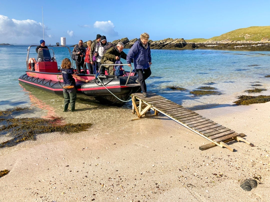 Passengers disembarking from the Handa Ferry on to the beach