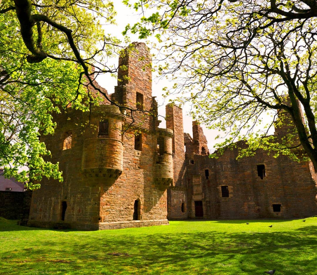 Earl's-Palace-Kirkwall - a ruined building set on a green lawn surrounded by trees