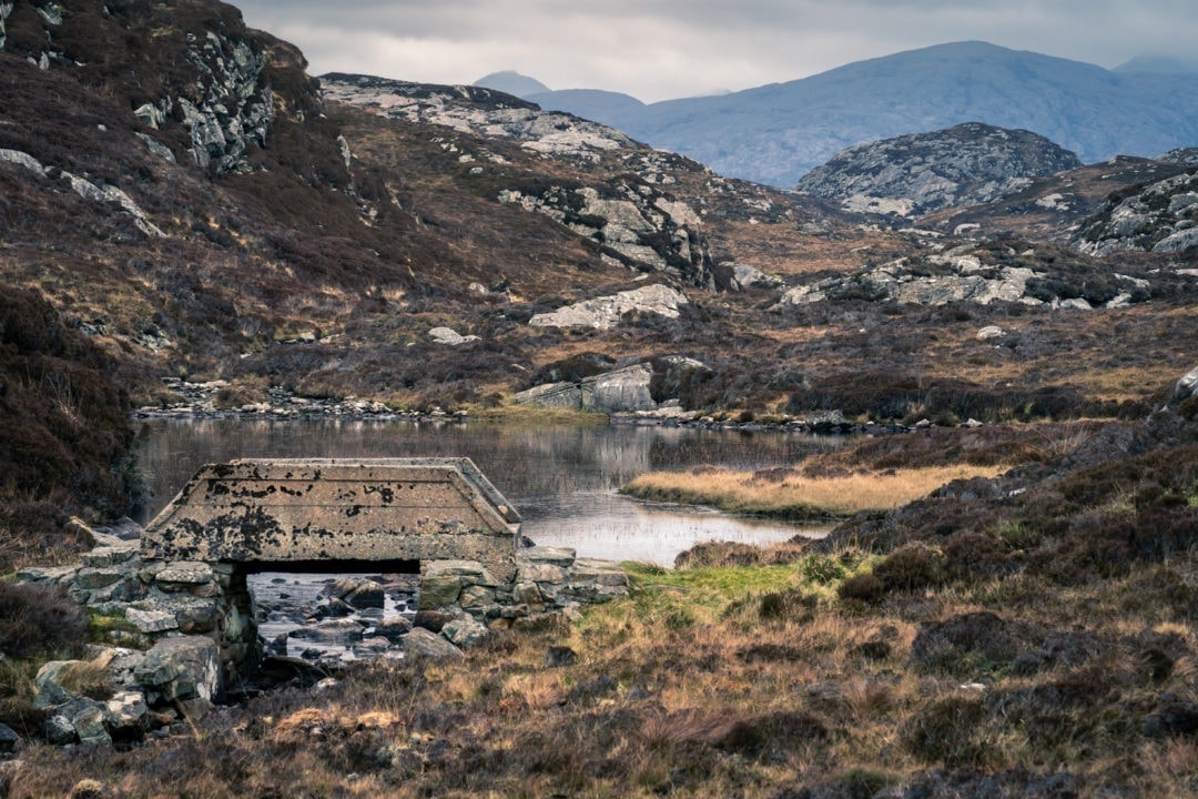 Loch, moorland and craggy stone landscape on the Golden Road