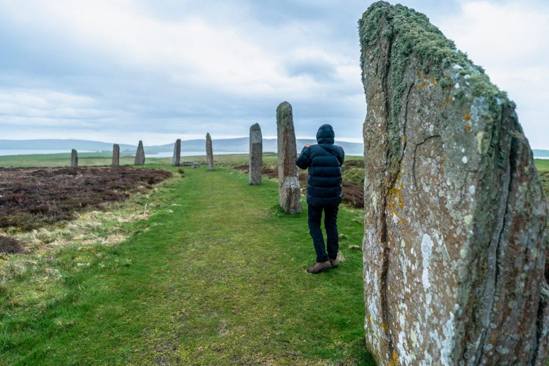 Dressed up warm with puffer jacket, waterproof trousers and walking boots at the Ring of Brodgar