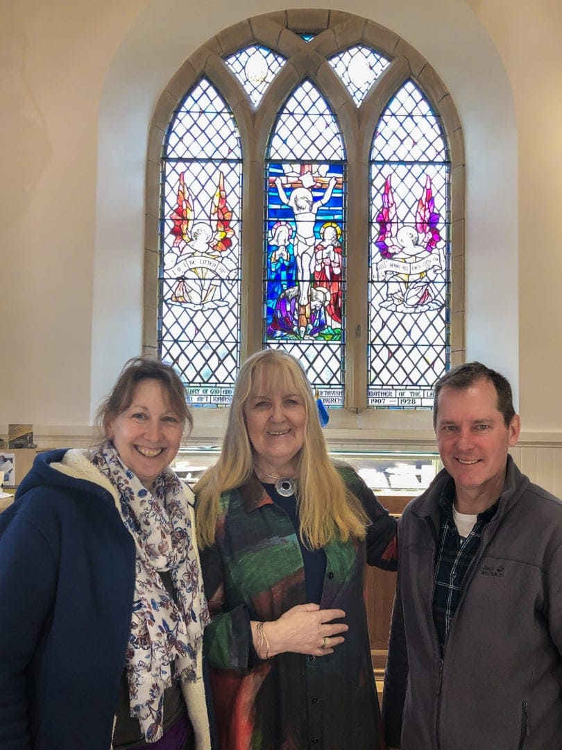 Sheila Fleet and us at the end of the Jewellery Gallery by a stained glass window