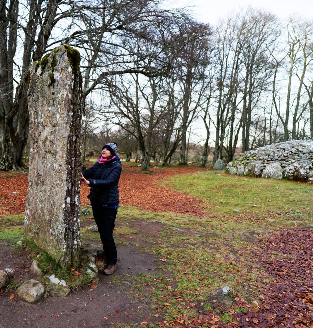 Shelley stood by a standing stone at Clava Cairns