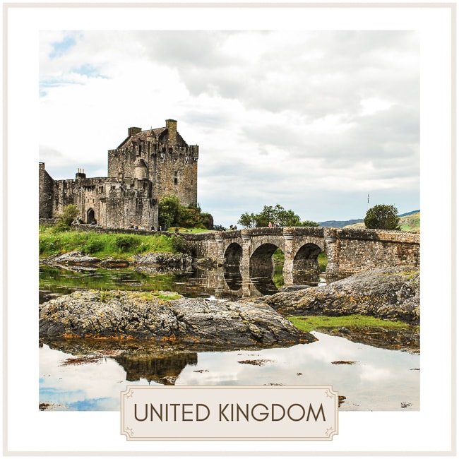 united kingdom image of a stone castle beside a stone bridge over a river