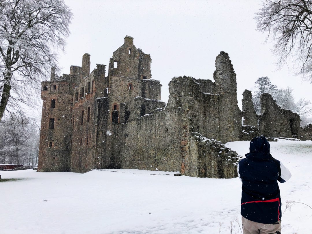 Huntly-Castle ruins in the snow with person looking on 
