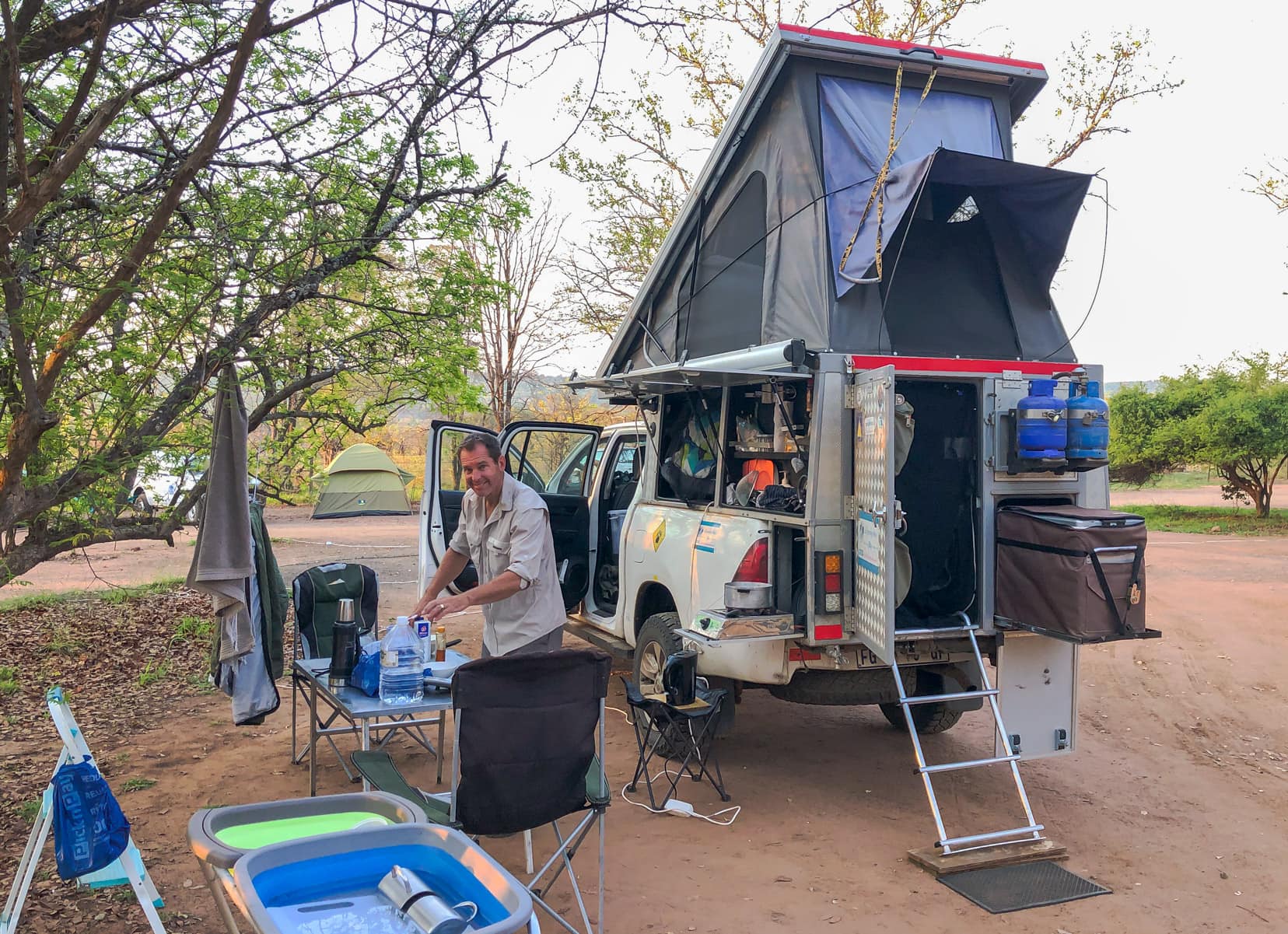 travelling cheaply in a 4x4 bush camper with tent popped up and sides open