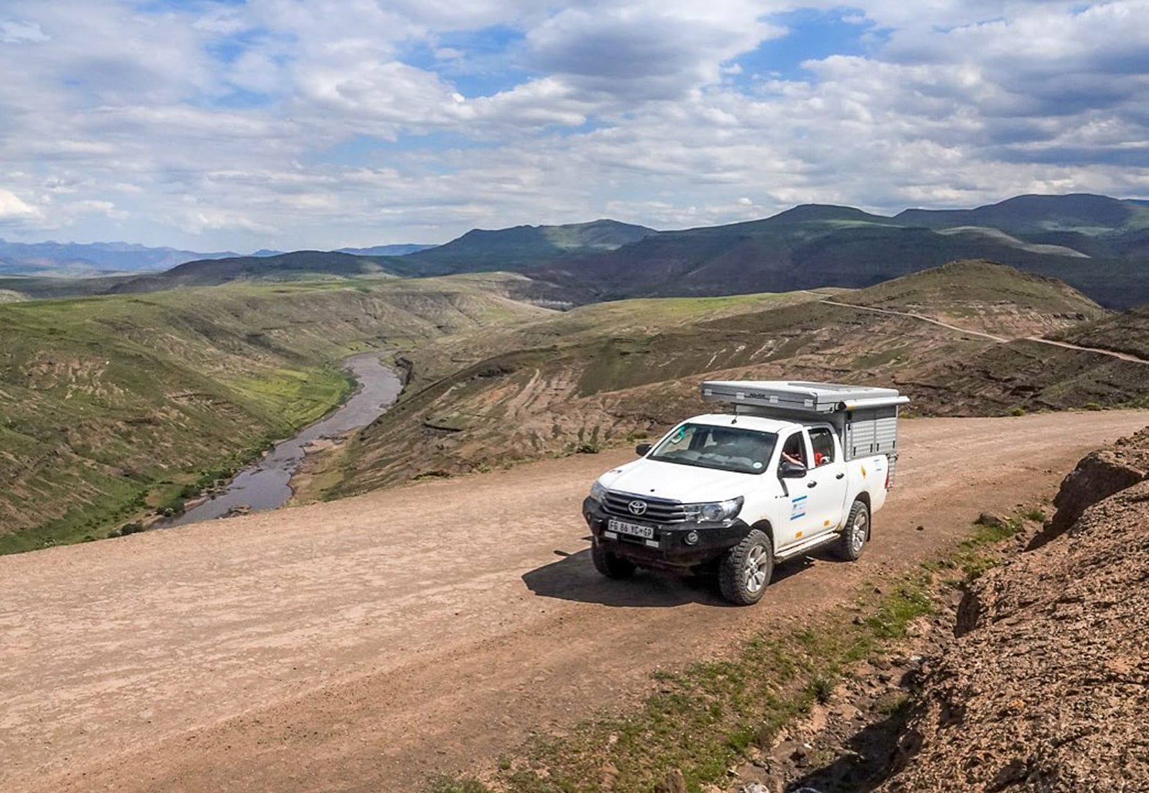 4wd on a dirt road with mountain back drop