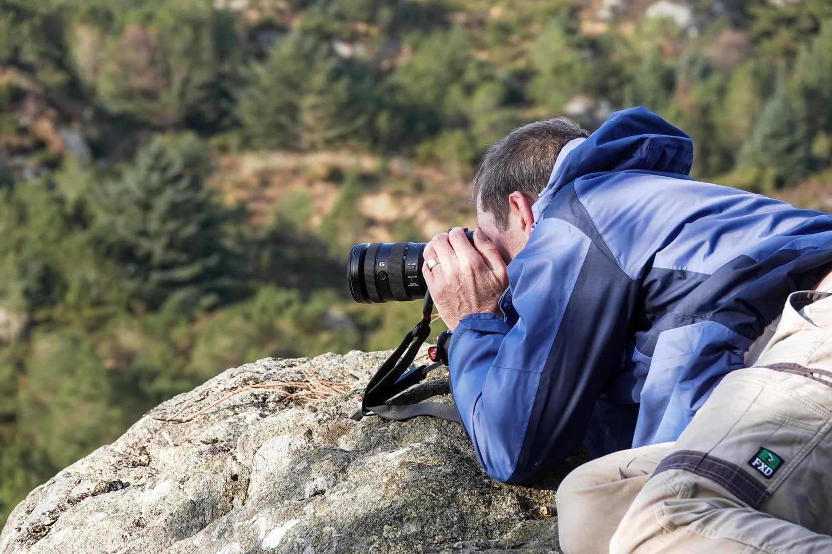 Man-shooting-with-camera-off-a-small-manfrotto-tripod