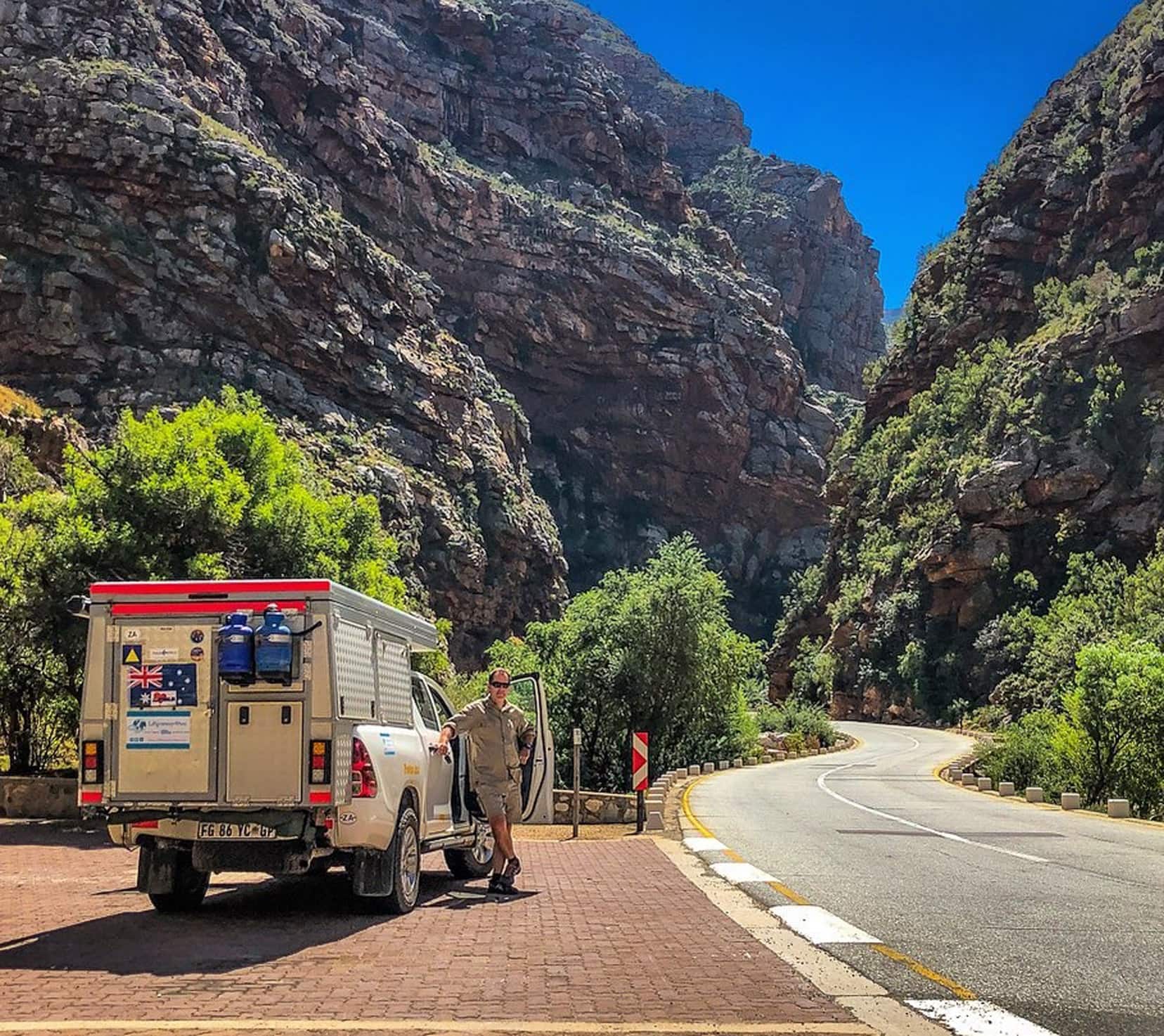 road through a gorge with a 4wd in the foreground