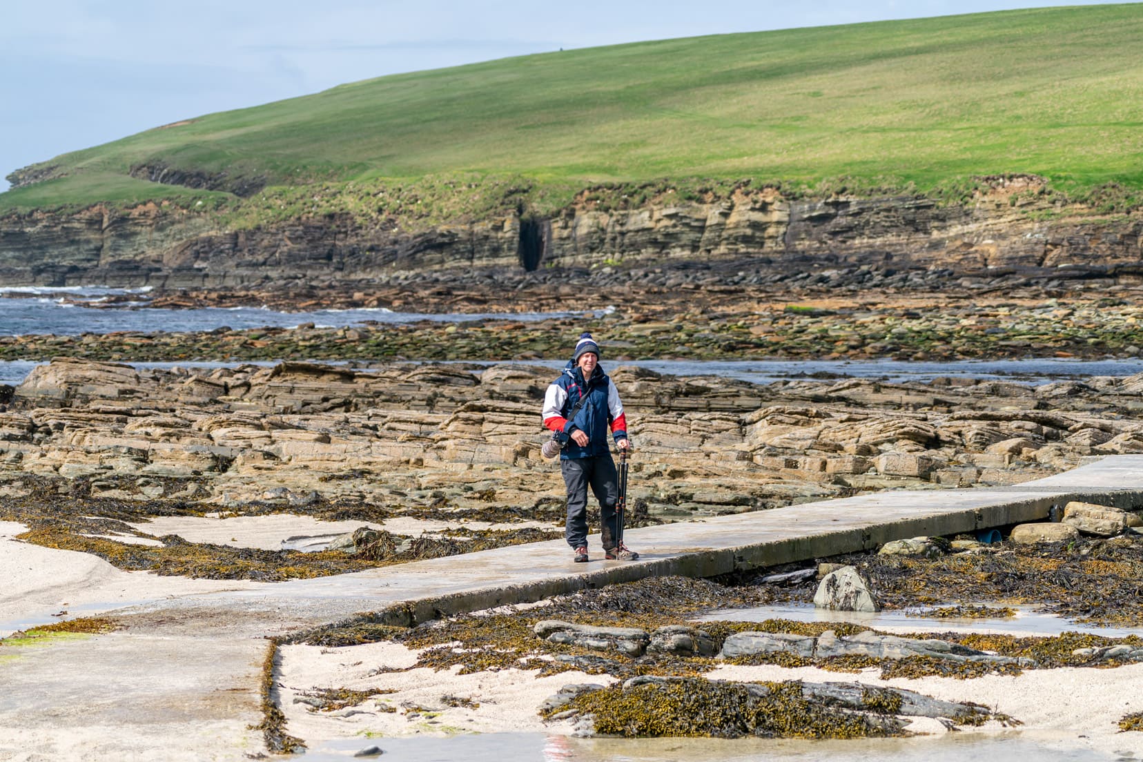 exposed causeway at low tide with a concrete crossing path