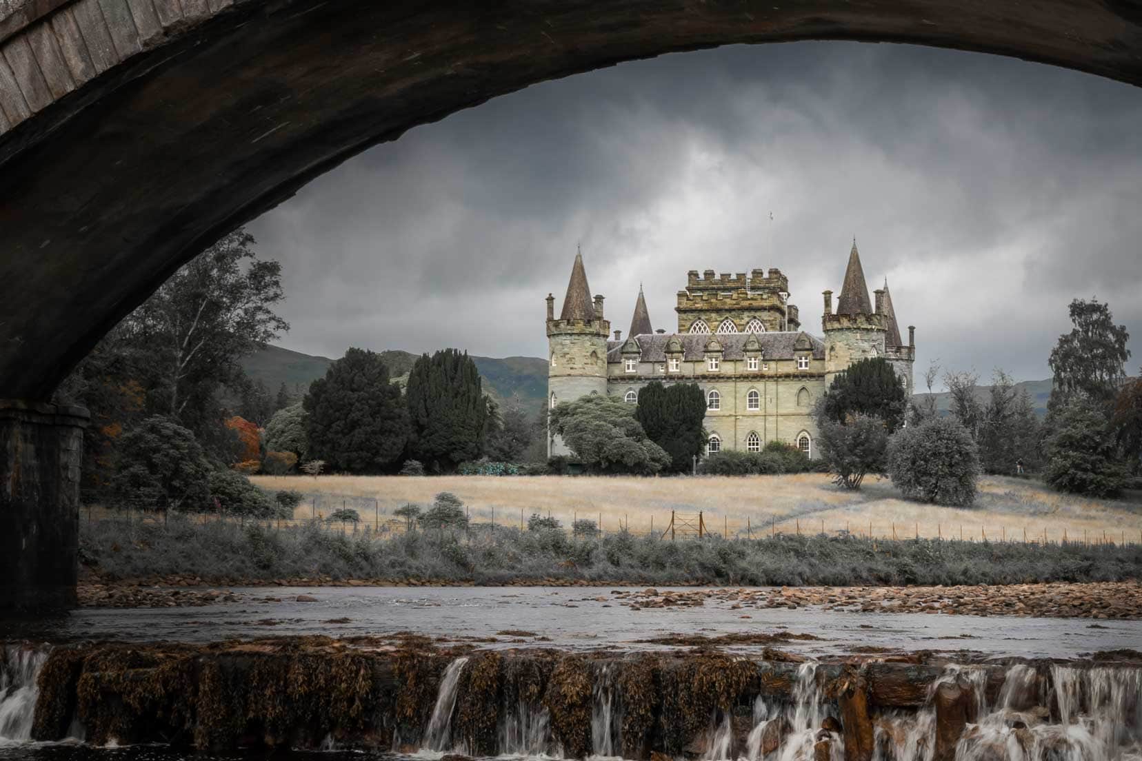 Inveraray-Castle_framing-the-shot with an arched stone bridge