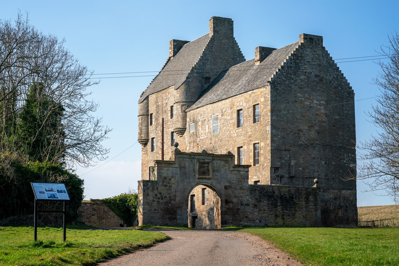 Midhope Castle with stone arch gateway 