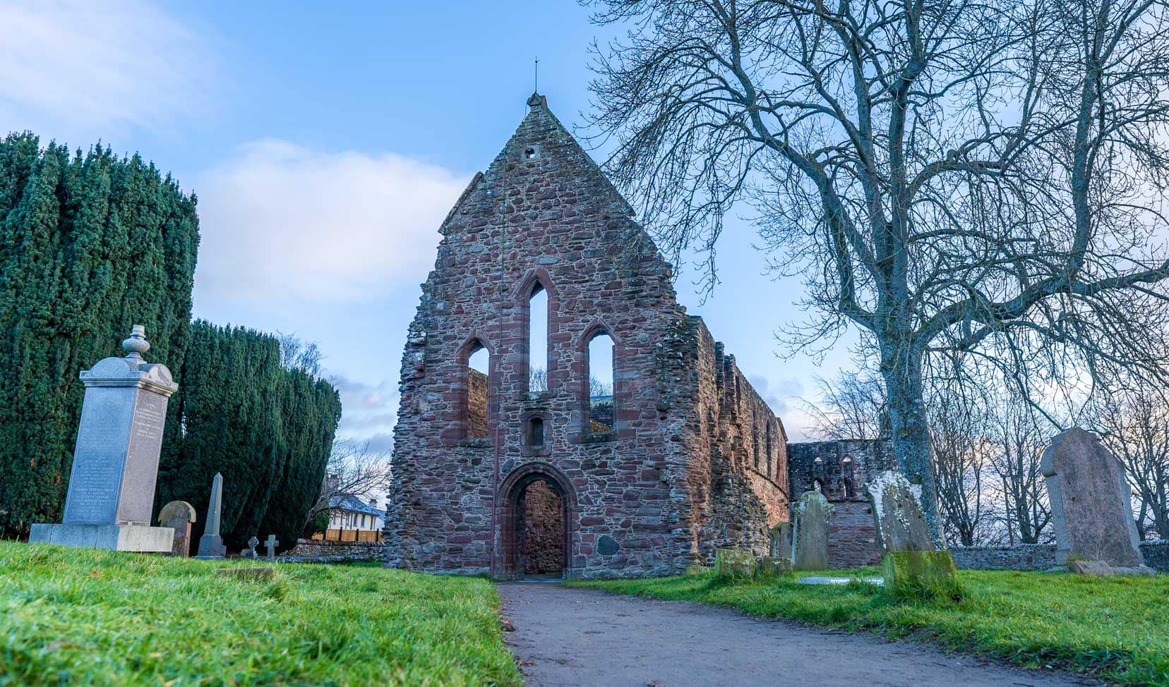 Beauly-Prior in a churchyard with graves