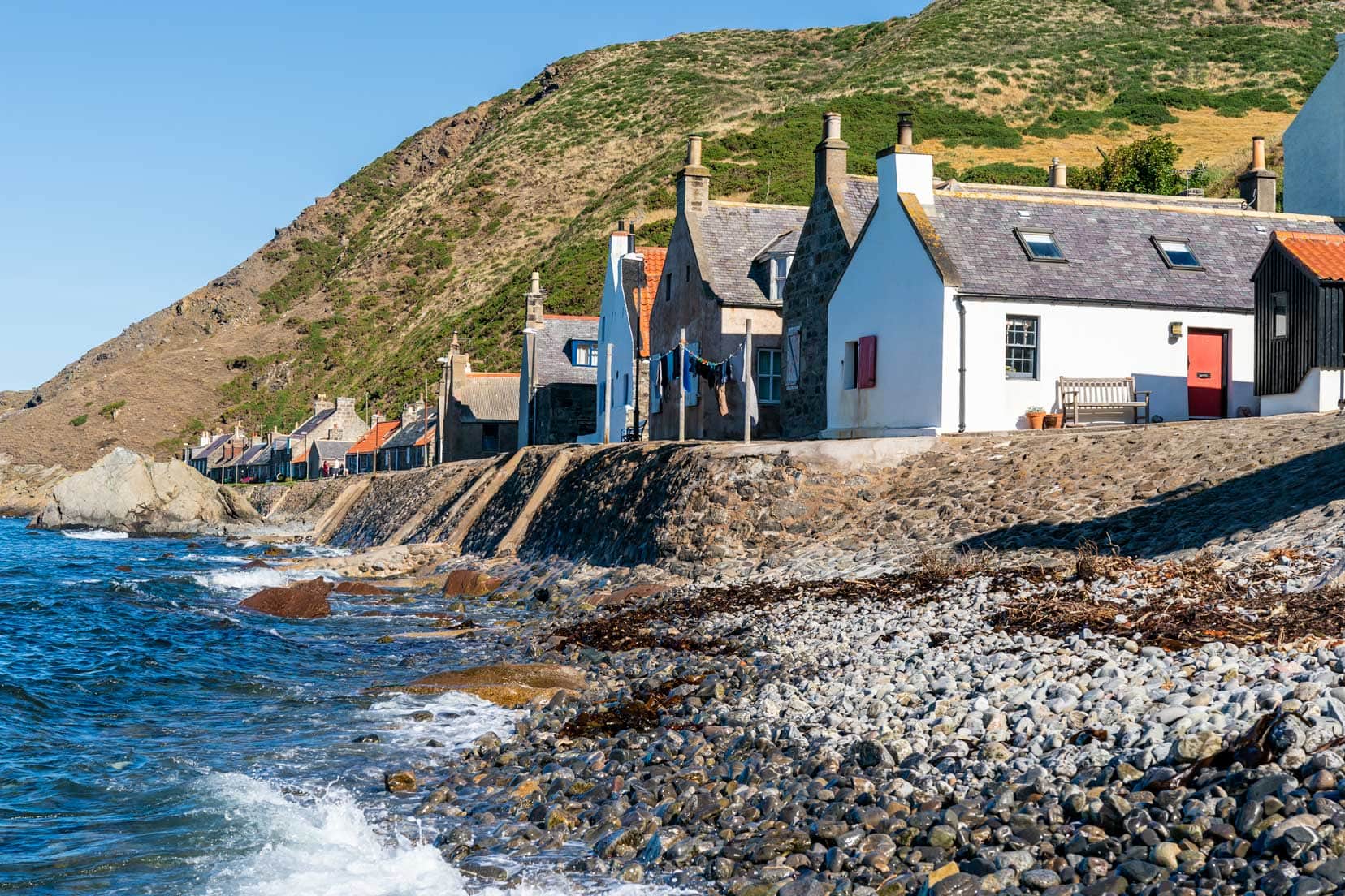 Aberdeenshire Crovie Bay with houses along the harbour wall