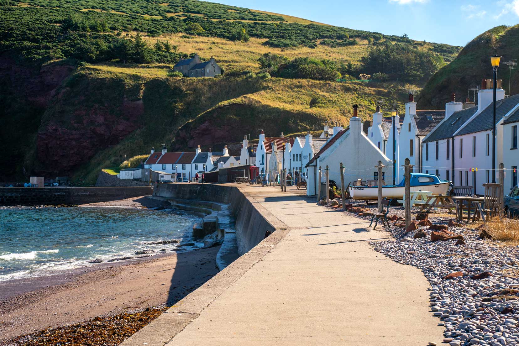 Pennan village - row of houses beside harbour wall