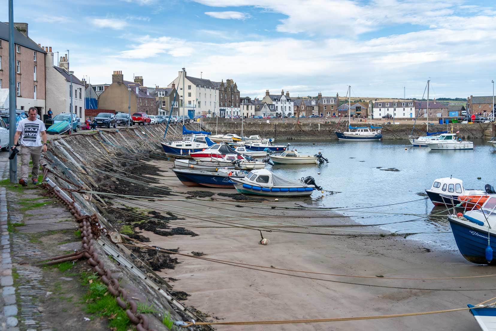 Stonehaven harbour wth lots of fishing boats moored at low tide