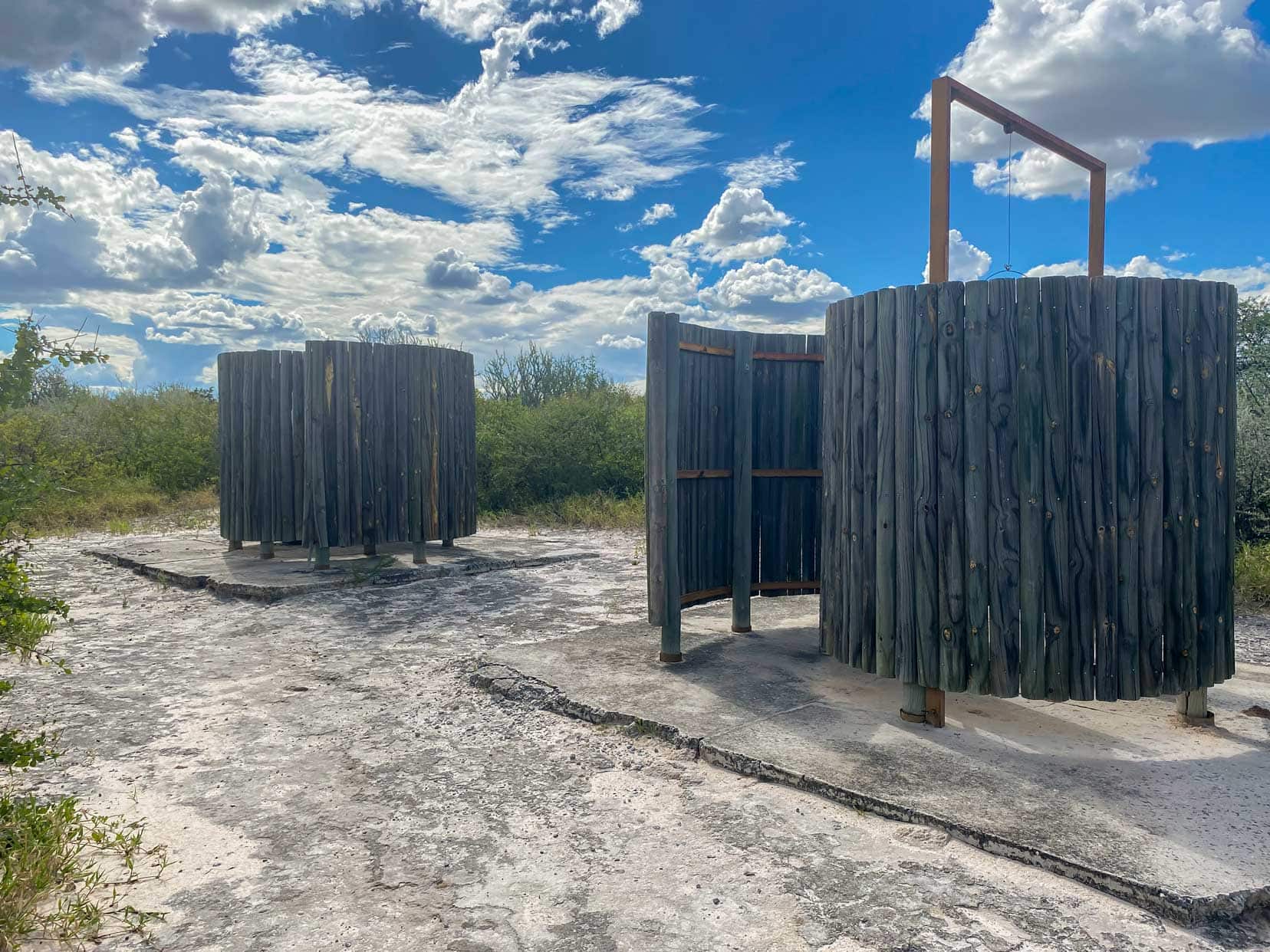 Piper Pan two rounded shelters containing a drop toilet and in the other a bucket shower